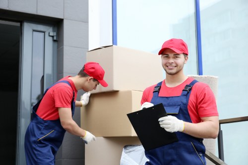 Man and van team loading furniture in Docklands near modern apartments
