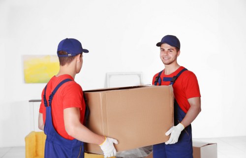 Mover carrying furniture from a Docklands apartment building