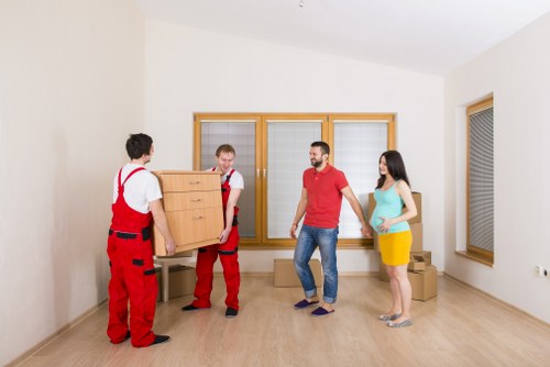 Man and van loading furniture in a Docklands apartment area